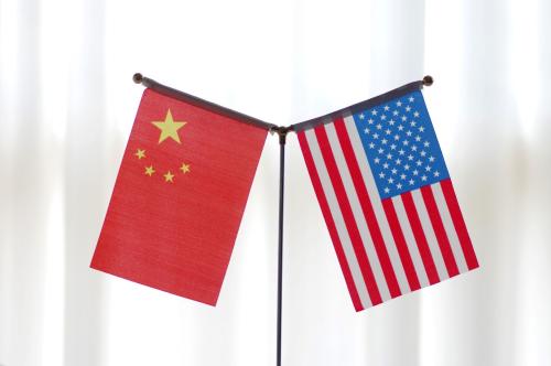 National flags of China and the United States are seen in Ji'nan city, east China's Shandong province, 14 June 2018.