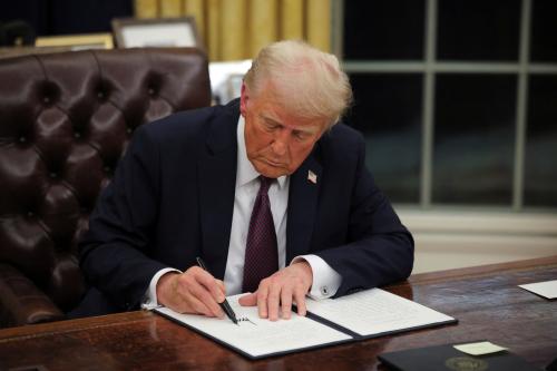 U.S. President Donald Trump signs documents as he issues executive orders and pardons for January 6 defendants in the Oval Office at the White House on Inauguration Day in Washington, U.S., January 20, 2025.