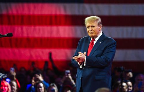 Donald Trump clapping his hands at a rally.