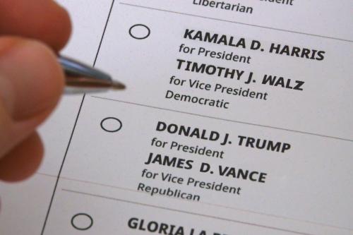 California, USA, Aug. 7, 2024: A hand hovers between voting for Kamala Harris and Tim Walz or Donald Trump and JD Vance on a representation of a printed paper ballot for the presidential election.