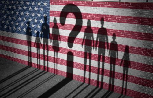 Illustration of a brock wall painted with an American flag, with shadows of people to either side of the shadow of a question mark