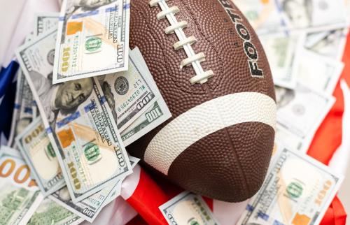 Football and dollars on American flag